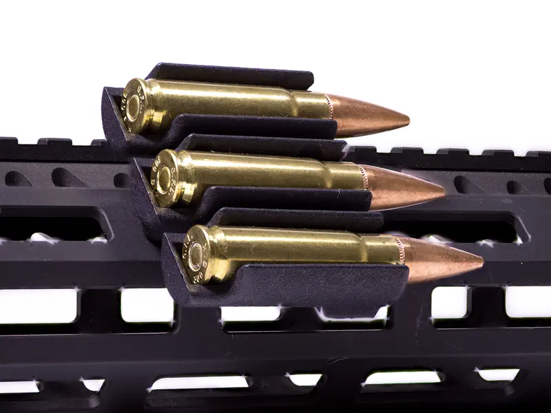 Ammo Carrier for M-LOK rail holding three .223 rounds on a rifle