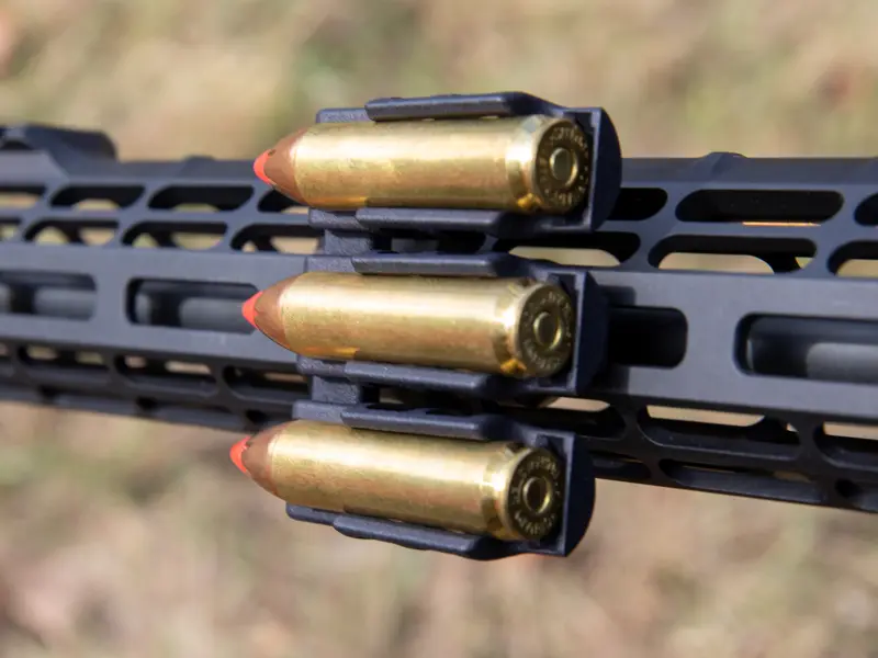 Close-up of large caliber chambers holding various big game cartridges securely