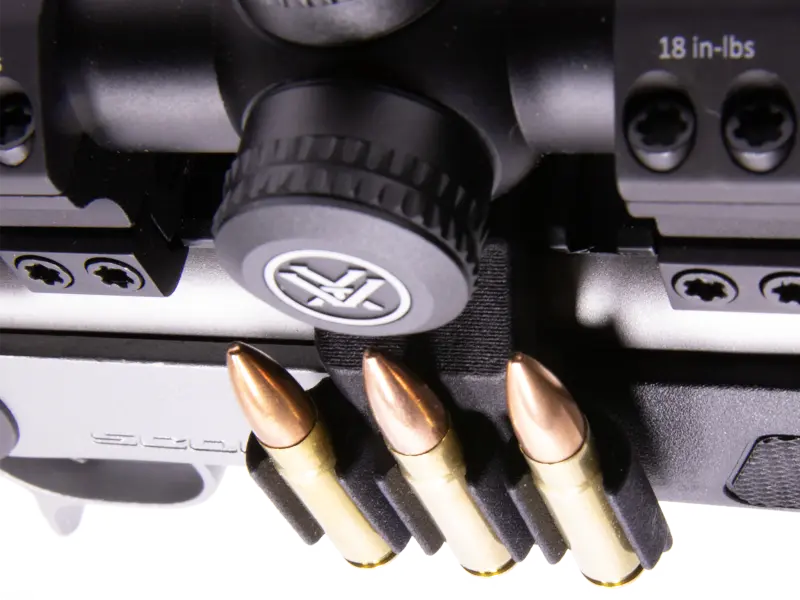 Detailed view of Picatinny clamp mechanism showing secure multi-slot engagement
