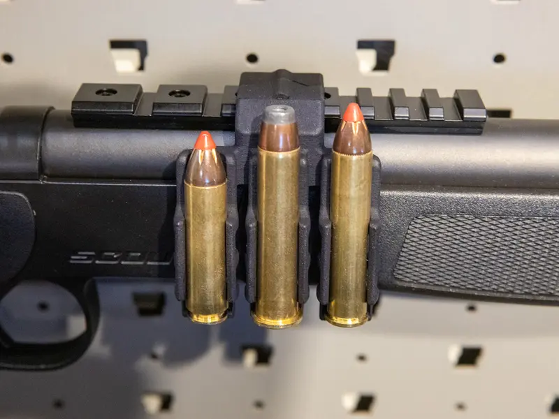 Ammo Carrier for CVA Scout Picatinny rail holding three .450 Bushmaster rounds on a rifle