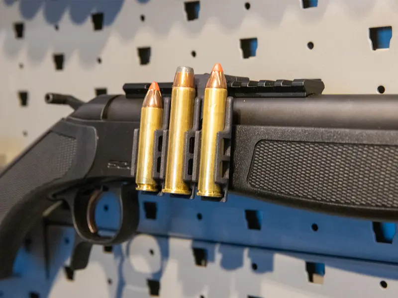 Ammo Carrier for CVA Scout Picatinny rail holding three .450 Bushmaster rounds on a rifle