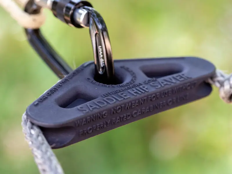 Saddle Hip Saver attached to carabiner showing universal mounting compatibility