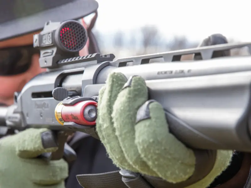 Side view of the shell holder showing its low-profile fit on a shotgun